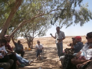 Azziz Al-Turi holds up his Israeli ID card two days after his villages was demolished. Clothing was stored on trees. 